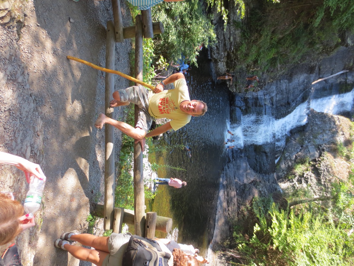 a Barefoot Hiker relaxes overlooking a waterfall in the Pocono Mountains