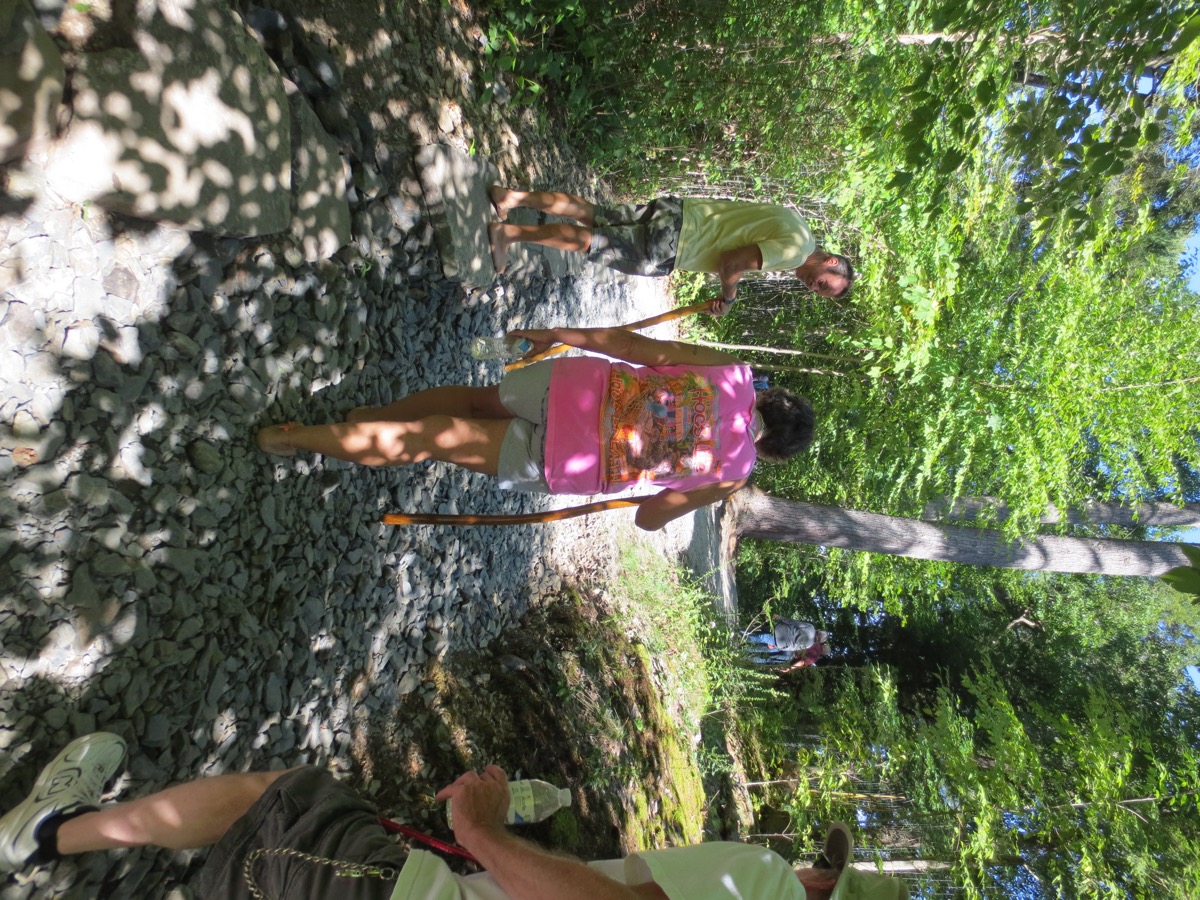 a Barefoot Hiker traverses terrain with large gravel and rocks