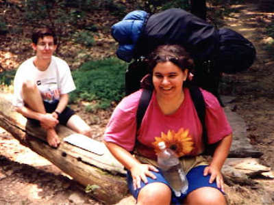 Barefoot Hikers Marian and Chris Rest on a Log