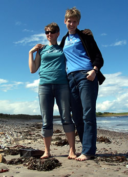 Isis and jackrabbit on a beach in Scotland wearing Barefoot Hikers shirts
